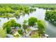 An aerial view shows homes nestled among trees and next to a tranquil lake at 242 W Warford Dr, , IN 46164