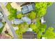 An aerial view shows a home with a lush green yard and a pathway leading to a waterfront area at 242 W Warford Dr, , IN 46164