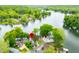 An aerial view shows homes nestled among trees and next to a tranquil lake at 242 W Warford Dr, , IN 46164