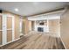 Wide angle of a basement featuring hardwood floors, paneled walls, and doors leading to other rooms at 242 W Warford Dr, , IN 46164