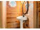 Charming bathroom with wood paneled walls, white pedestal sink, and unique octagon window at 242 W Warford Dr, , IN 46164