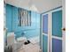 Cozy blue-painted bathroom with a toilet, sink, and window with curtains, plus a closet with bifold doors at 242 W Warford Dr, , IN 46164