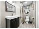 Stylish bathroom featuring a black vanity, modern fixtures, and decorative mirrors at 242 W Warford Dr, , IN 46164