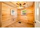 Simple wood-paneled bedroom with a window, ceiling fan, and neutral flooring at 242 W Warford Dr, , IN 46164