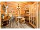 Wood-paneled dining room with round table and chairs, showcasing rustic charm and decor at 242 W Warford Dr, , IN 46164