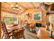 Dining area featuring wood paneling, round table and chairs, and natural light from windows at 242 W Warford Dr, , IN 46164