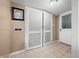 Hallway with tiled flooring, louvered doors, a picture frame, and access to other rooms at 242 W Warford Dr, , IN 46164