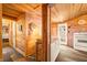 Cozy kitchen featuring wooden walls and cabinets, a door to the outside, and modern appliances at 242 W Warford Dr, , IN 46164