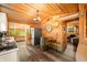 Cabin-style kitchen featuring wood walls and barrel accents, with modern stainless steel refrigerator at 242 W Warford Dr, , IN 46164