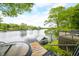 Picturesque lake view from the deck with seating area and charming boathouse for waterfront enjoyment at 242 W Warford Dr, , IN 46164