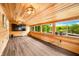 Bright sunroom with floor-to-ceiling windows, wood paneling, and modern flooring overlooking lake at 242 W Warford Dr, , IN 46164