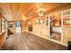A bright sunroom featuring wood-paneled walls and ceiling, hardwood floors and an open view into the kitchen at 242 W Warford Dr, , IN 46164