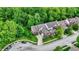 Beautiful aerial view of a red brick house with mature trees and a circular driveway at 2592 Highmount Ct, Carmel, IN 46033