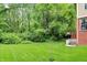 Well-maintained backyard with lush grass, mature trees, and access to the basement at 2592 Highmount Ct, Carmel, IN 46033