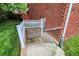 Basement entrance with brick and stone accents, stairs, and white picket fence at 2592 Highmount Ct, Carmel, IN 46033