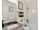 Bathroom features a shower-tub combo, framed mirror, and a modern gray countertop sink at 2592 Highmount Ct, Carmel, IN 46033