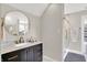 Bathroom with a modern vanity with a marble countertop and gold fixtures at 2592 Highmount Ct, Carmel, IN 46033