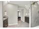 Bathroom with a dual vanity with stone countertops and a view into the bedroom at 2592 Highmount Ct, Carmel, IN 46033