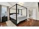 Spacious bedroom featuring a four-poster bed, tray ceiling, and hardwood floors at 2592 Highmount Ct, Carmel, IN 46033