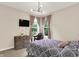 Bright bedroom features two windows, a comfy patterned bed, and a dresser with TV at 2592 Highmount Ct, Carmel, IN 46033