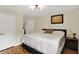 Bedroom with hardwood floors, bright light, and a queen-sized bed features two doors and a large window at 2592 Highmount Ct, Carmel, IN 46033