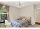 Bedroom boasts a bed with patterned bedding and a large window with lush greenery views at 2592 Highmount Ct, Carmel, IN 46033