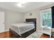 Cozy bedroom features hardwood floors, a queen bed, large window, and an accent rug at 2592 Highmount Ct, Carmel, IN 46033