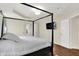 This bedroom has hardwood floors, a four-poster bed, and a television on the wall at 2592 Highmount Ct, Carmel, IN 46033