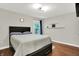 Comfortable bedroom with hardwood floors, a queen-sized bed, and a window to a backyard view at 2592 Highmount Ct, Carmel, IN 46033