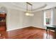 Elegant dining room with hardwood floors, decorative lighting, and a glimpse into the adjacent kitchen at 2592 Highmount Ct, Carmel, IN 46033