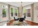 Bright dining room with wooden floors, big windows, modern lighting, and stylish decor at 2592 Highmount Ct, Carmel, IN 46033