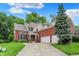 Charming brick home boasts a spacious driveway, lush landscaping, and an attached two-car garage at 2592 Highmount Ct, Carmel, IN 46033
