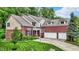 Beautiful two-story brick home with three-car garage and manicured lawn at 2592 Highmount Ct, Carmel, IN 46033