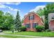 Charming red brick home with black shutters surrounded by a well-maintained lawn and mature trees at 2592 Highmount Ct, Carmel, IN 46033