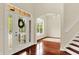 Elegant foyer with hardwood floors, staircase, and decorative glass front door, offering a welcoming entrance at 2592 Highmount Ct, Carmel, IN 46033