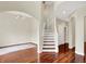 Open foyer with hardwood floors, staircase, and elegant archways leading to other rooms at 2592 Highmount Ct, Carmel, IN 46033
