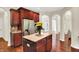 Kitchen island, stainless steel refrigerator, and wood cabinets at 2592 Highmount Ct, Carmel, IN 46033