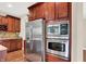 Kitchen boasts stainless steel refrigerator, oven, microwave, and cherry cabinets at 2592 Highmount Ct, Carmel, IN 46033