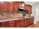 Kitchen features wood cabinets, stainless microwave and granite counters at 2592 Highmount Ct, Carmel, IN 46033