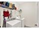 Functional laundry room with a washer, dryer, and plenty of storage space on shelves at 2592 Highmount Ct, Carmel, IN 46033