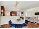 Open-concept kitchen/dining area with wood floors, stylish lighting, and modern appliances at 2592 Highmount Ct, Carmel, IN 46033