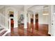 Spacious living area featuring hardwood floors, white pillars, and seamless transition into the kitchen at 2592 Highmount Ct, Carmel, IN 46033