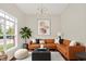 Comfortable living room with corner sofa, decorative pillows, modern lighting, and bright window view at 2592 Highmount Ct, Carmel, IN 46033