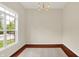 Bright living room featuring wood floors, a large window with treelined street view, and modern lighting at 2592 Highmount Ct, Carmel, IN 46033