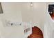 View of hardwood staircase with white railing and open space with warm lighting at 2592 Highmount Ct, Carmel, IN 46033
