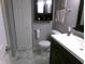 Modern bathroom featuring a black vanity with a white sink, and gray walls and floors at 2628 Newaygo Dr, Indianapolis, IN 46217