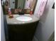 Bathroom vanity with a granite-look countertop and a dark wood cabinet at 2628 Newaygo Dr, Indianapolis, IN 46217