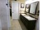 A bathroom offering a granite-look double vanity, and neutral wall and floor tiles at 2628 Newaygo Dr, Indianapolis, IN 46217