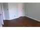 A clean bedroom with light blue walls and dark wood floors offers a peaceful space at 2628 Newaygo Dr, Indianapolis, IN 46217