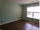 Comfortable bedroom with wood-look flooring, and bright natural light perfect for rest and relaxation at 2628 Newaygo Dr, Indianapolis, IN 46217